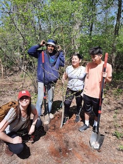 Planting trees along the stream bank to present erosion in Phil Rizzuto Park during Groundwork Elizabeth’s Earth Day Celebration.